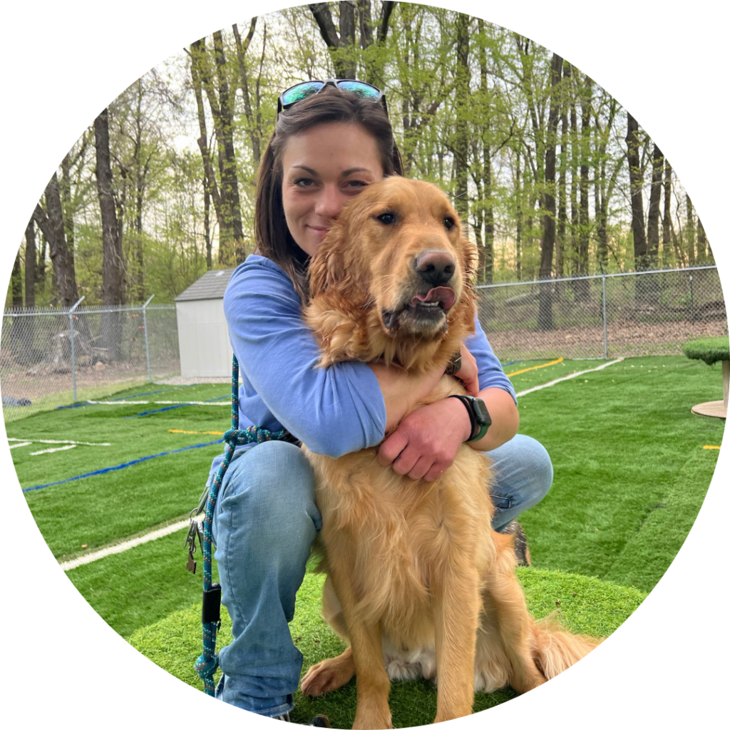 Magnolia Dog Ranch owner, Jordan Engle, hugging a dog