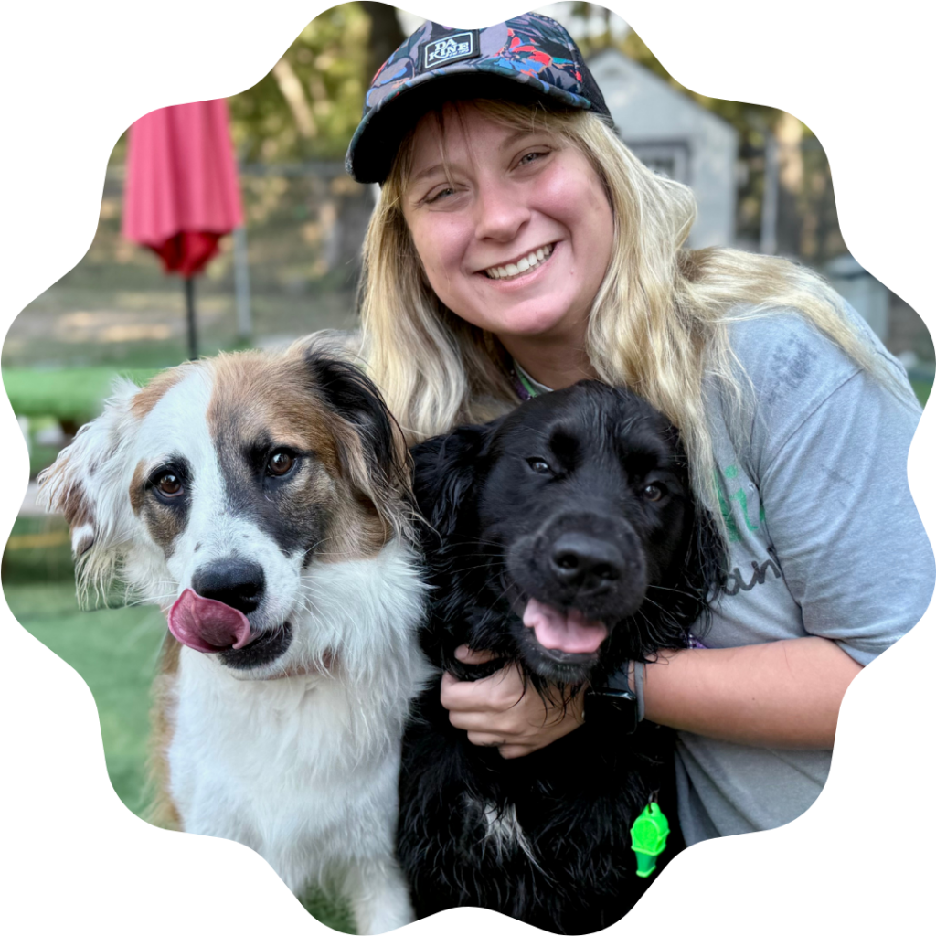 Maddie Gross hugging two dogs